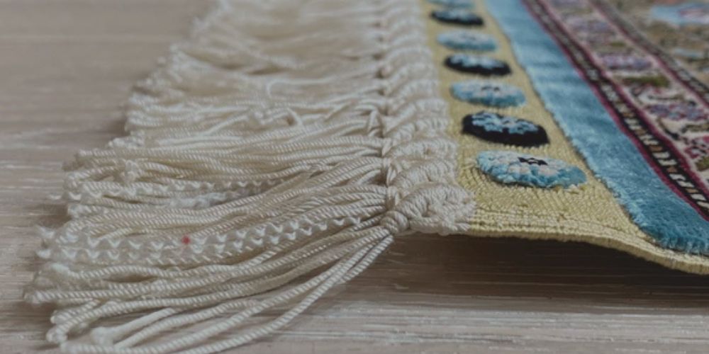 Close-up of handmade rug fringe and woven edge detail showing craftsmanship